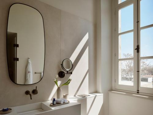 a bathroom with a mirror and a sink at Amyth of Nicosia in Nicosia