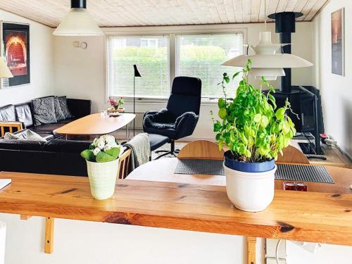 a living room with two potted plants on a table at 4 person holiday home in Broager-By Traum in Broager