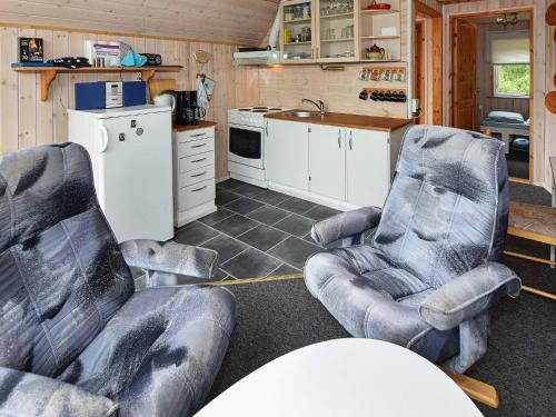 a kitchen with two chairs and a kitchen with a sink at 5 person holiday home in Grindsted in Tofterup