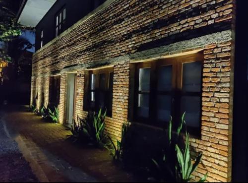 a brick building with windows and plants in front of it at Serendipity in Colombo
