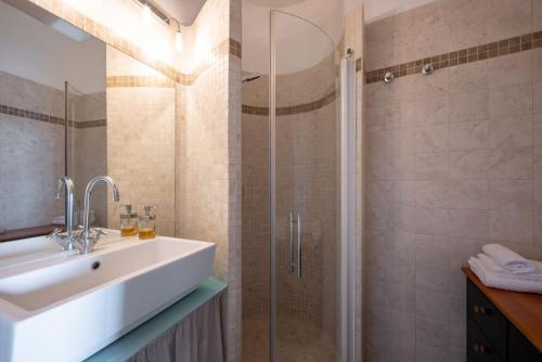 een badkamer met wastafel en douche bij Il Torrino in Campiglia Marittima