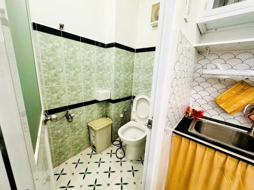 a small bathroom with a toilet and a sink at LoCo's FullHouse - SAIGON CENTRE - D1 in Ho Chi Minh City