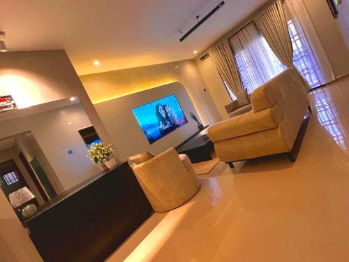a living room with a couch and a chair at Home2Suite by Veronica Bunga-Buziga-Munyonyo- Luxury with Netflix, DStv, Wi-Fi, & Free Parking in Kampala