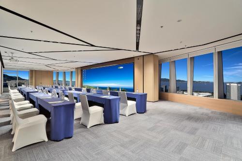 a conference room with blue tables and white chairs at voco Zhoushan Putuo by IHG in Zhoushan