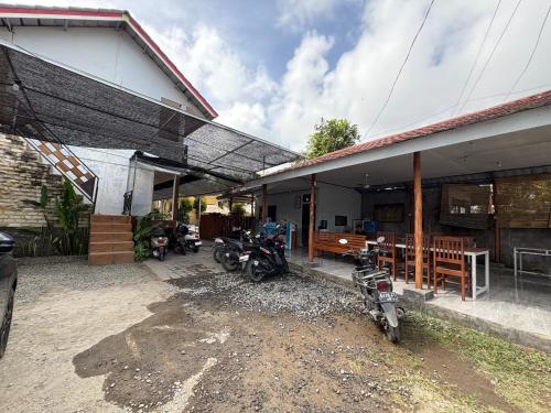 a group of motorcycles parked outside of a building at Jeri Home Stay in Kuta Lombok