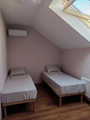 two twin beds in a room with a window at Like Hostel in Chişinău