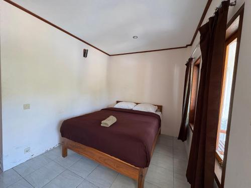 a small bedroom with a bed in a room at Jeri Home Stay in Kuta Lombok