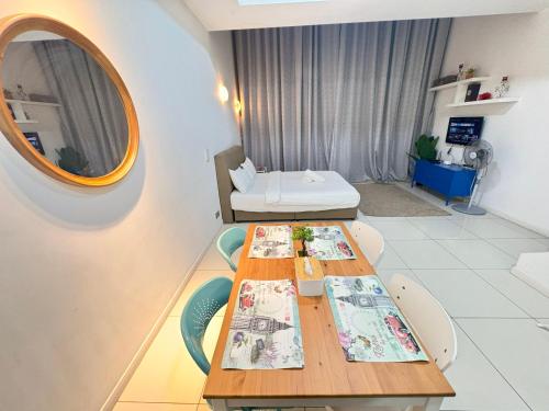 a dining room with a table and a mirror at Mcity Ampang Residence in KL in Kuala Lumpur