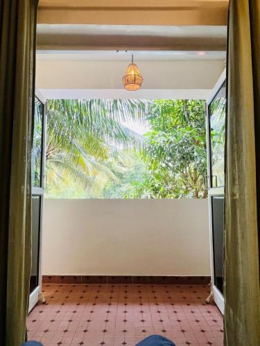 a room with a large window with a view at Namaste at Beachside 2BHK, with Free Breakfast in Varca