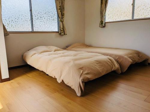 two beds in a corner of a room at Amami North Mangrove Inn - Vacation STAY 90032v in Amami