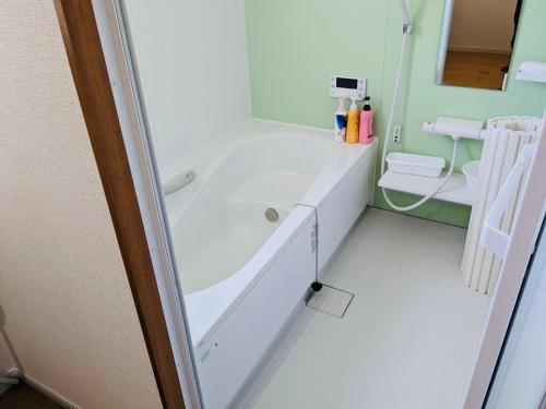 a bathroom with a tub and a sink and a toilet at Amami North Mangrove Inn - Vacation STAY 90032v in Amami