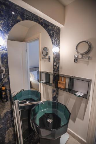 a bathroom with a green sink and a mirror at Santa Boka in Perast