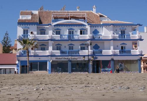 a hotel on the beach next to the beach at Hotel Doña Luisa in San Luis de Sabinillas