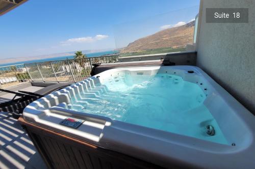 a hot tub on a balcony with a view of the ocean at Galilee Escape Private Pool or Jacuzzi Retreat in Migdal