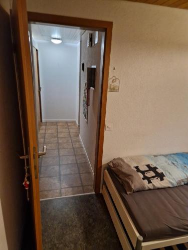 a bedroom with a bed and a door to a hallway at Ferienwohnung Pirol in Grenchen