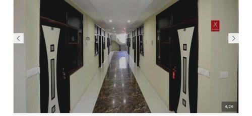 a corridor of a hallway with doors at Hotel O Alpine in Chandīgarh