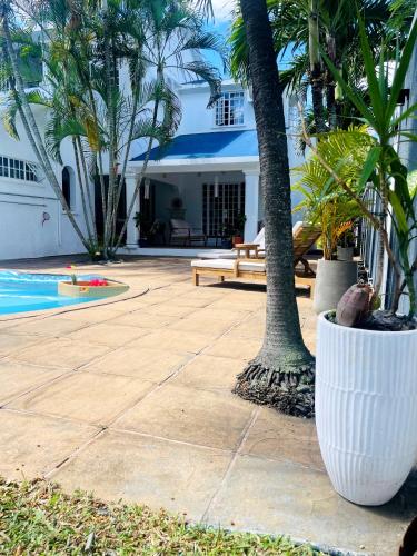 a resort with a pool and palm trees and a building at Villa Clotilde balaclava in Balaclava
