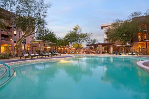 a large swimming pool with chairs in a building at Residence Inn by Marriott Scottsdale Salt River in Scottsdale