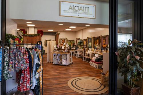 a store aisle with clothes on display in a store at Courtyard by Marriott King Kamehameha's Kona Beach Hotel in Kailua-Kona