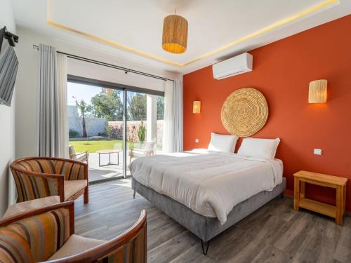 a bedroom with a bed and a large window at DAR PITXI - Personnel inclu in Essaouira