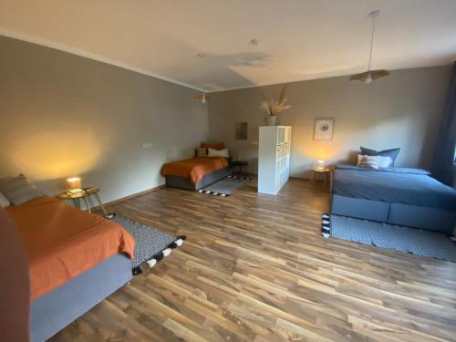 a bedroom with two beds and a wooden floor at Ferienhaus im Grünen in Bad Hersfeld