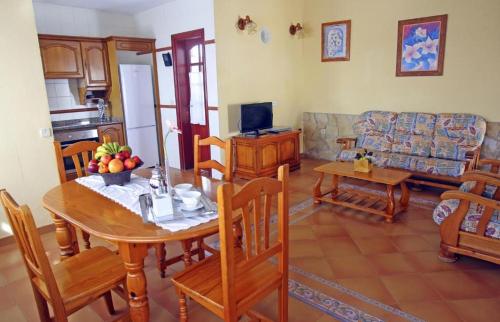 a living room with a table and a couch at Caleta Dorada in Caleta De Fuste