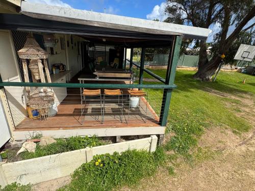 a house with a deck with chairs on it at dhu drop inn in Cervantes