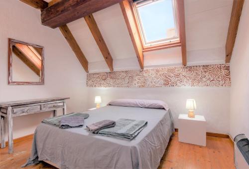 a bedroom with a bed in a room with a window at Rustico C in Tarifa