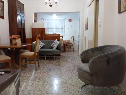 a living room with chairs and a couch and a table at Sweet Home Lefkas in Lefkada