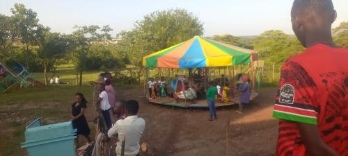 a group of people standing under a tent at Whitehouse house Lodge in Thika