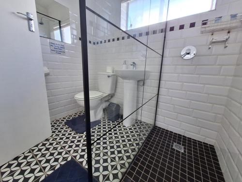a bathroom with a toilet and a glass shower at Holiday home by the River with Jetty in Port Alfred