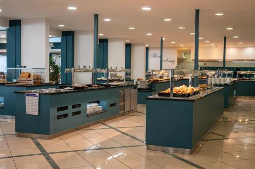 a restaurant with a buffet line with food on display at MASLINICA Narcis Hotel in Rabac