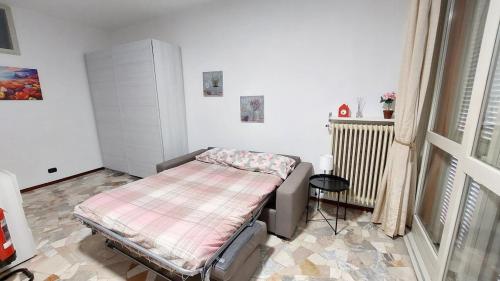 a small bedroom with a bed and a table at La veranda sul lago - spiaggia privata e vista lago in Porto Ceresio