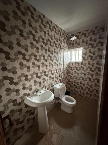 a bathroom with a toilet and a sink at Bollington Adex house 