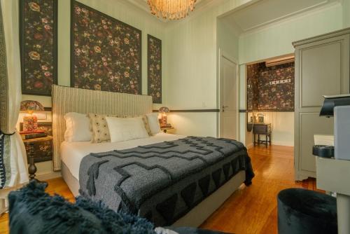 a bedroom with a bed and a chandelier at Solar dos Poetas in Lisbon