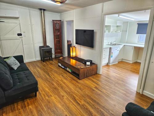 a living room with a couch and a coffee table at Lady Bay Beach House - seconds from the sand in Normanville