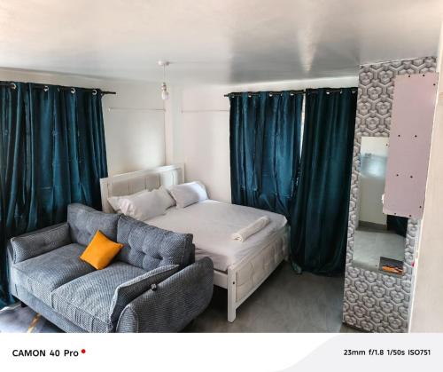 a living room with a couch and a bed at Diamond in the sky apartment in Nairobi