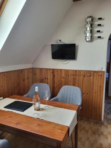 a dining room with a table and two chairs at Sklep u Veselých in Mutěnice