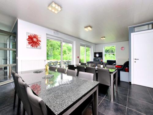 a dining room with a table and chairs at Luxurious Home with Sauna in Somme-Leuze