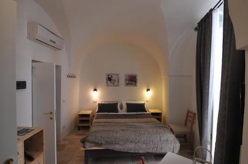 מיטה או מיטות בחדר ב-Porta San Michele