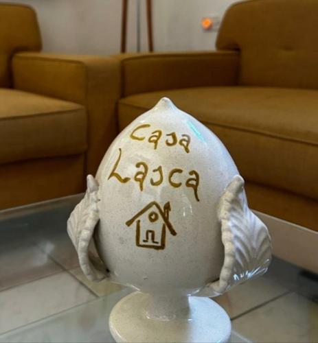 a white egg with writing on it on a table at Casa Lasca in San Marzano di San Giuseppe