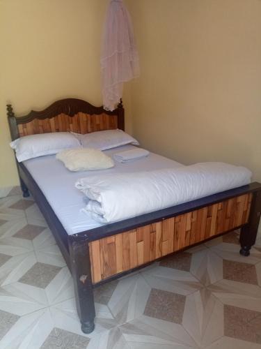Postel nebo postele na pokoji v ubytování EUGENE HOMES Guest House