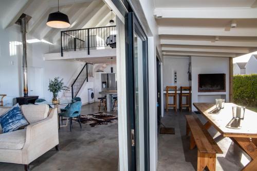 a living room with a couch and a table at Kelkiewyn in Yzerfontein in Yzerfontein