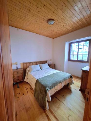 a bedroom with a bed and a wooden ceiling at Casa con alma canaria in Los Realejos