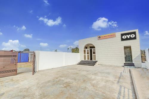 a white building with an okay sign on it at Hotel O The Heart Residency in Rāmgarh