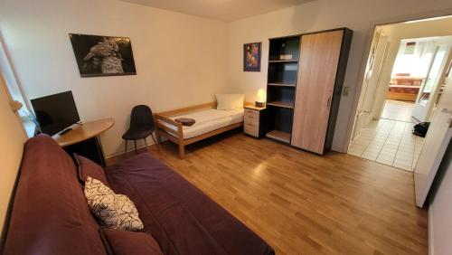 a living room with a couch and a desk at Monteurs-Apartment Graf Häseler in Lünen