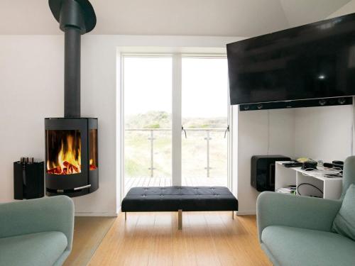 a living room with a fireplace and a couch at Luxury Seaside Retreat - By Traum Ferienwohnungen in Tranum Strand