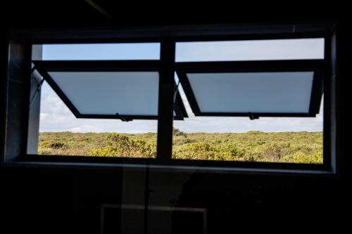 a window in a room with a view of a field at Kelkiewyn in Yzerfontein in Yzerfontein