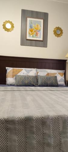 a bedroom with a large bed with two pillows at Love View Condotel in Piapi