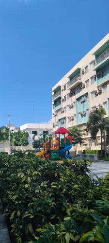 a playground with a train in front of a building at Love View Condotel in Piapi